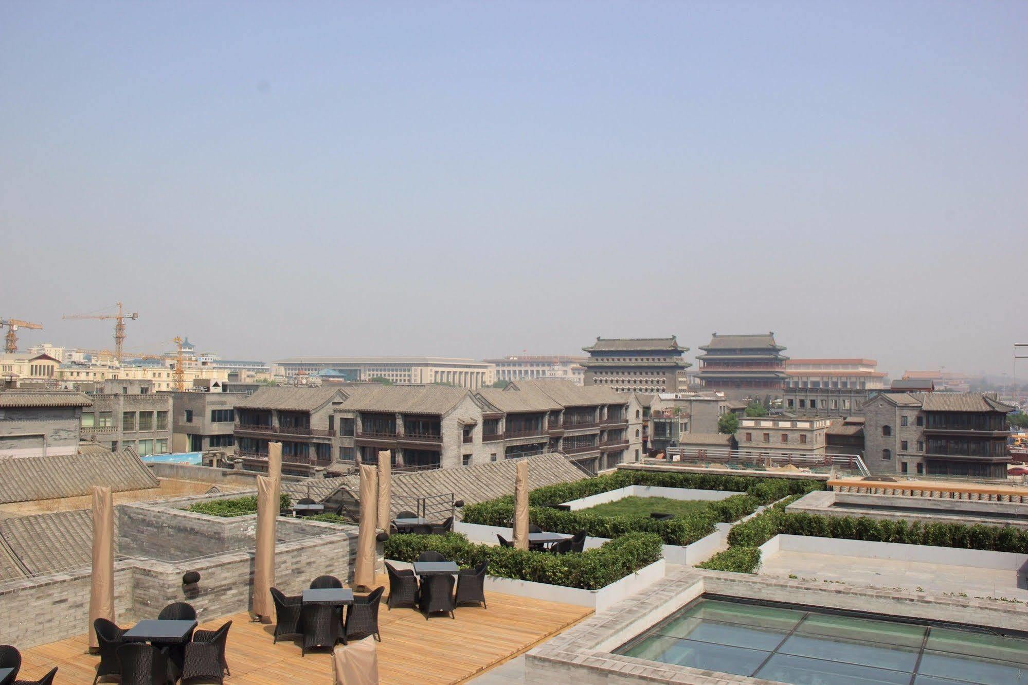 The Emperor Tiananmen Beijing Hotel Bagian luar foto The view of the Forbidden City from the rooftop of the hotel